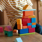 A child playing with the Glückskäfer 27 Piece Building Blocks Set.