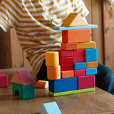 A child playing with the Glückskäfer 27 Piece Building Blocks Set.