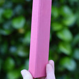 Largest blocks from the Glückskäfer 53 piece big provence wooden blocks set in an adult's hand.