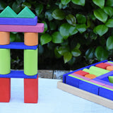 Glückskäfer 53 piece big provence wooden blocks set in a storage display tray with a tower created using some of the blocks built next to it.