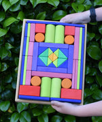 Glückskäfer 53 piece big provence wooden blocks set in a storage display tray in a child's hands.
