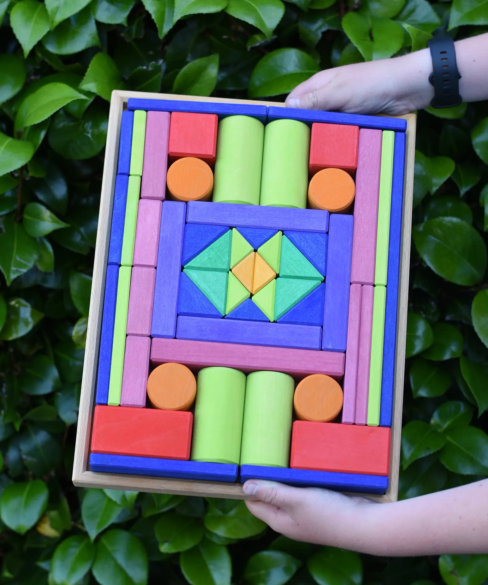 Glückskäfer 53 piece big provence wooden blocks set in a storage display tray in a child's hands.