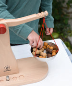 Child placing Grapat mandala pieces onto the Glückskäfer balance with weights children's weighing scales toy.  