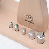 Close up of teh 5 weights included with the Glückskäfer balance with weights children's weighing scales toy.   