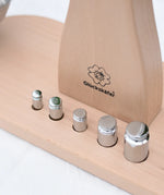 Close up of teh 5 weights included with the Glückskäfer balance with weights children's weighing scales toy.   