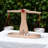 Glückskäfer balance with weights children's weighing scales toy placed on a table outdoors.  