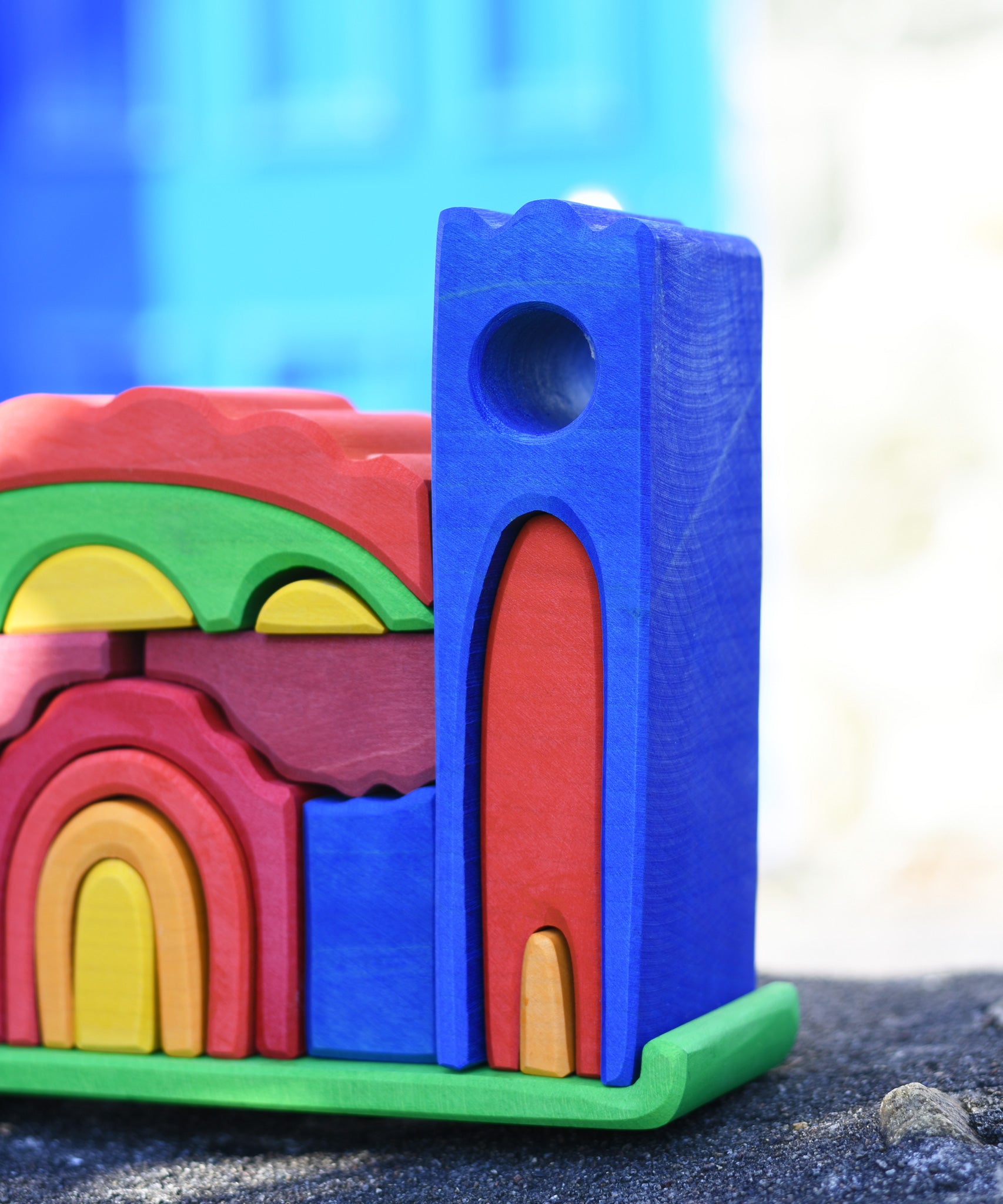 A close up of one of the tower pieces on the Gluckskafer blue castle wooden toy.