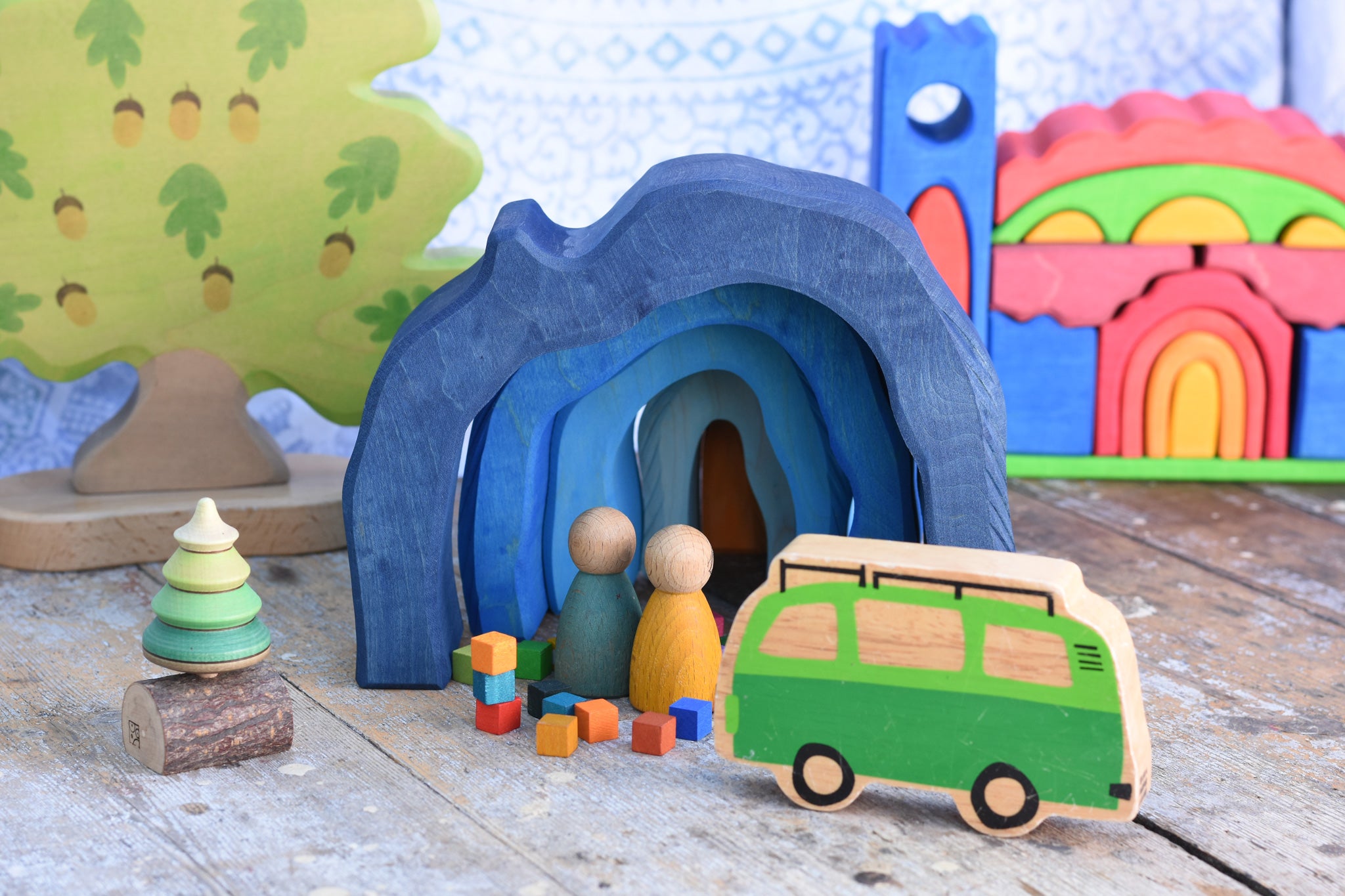 A small world play scene set up with the Glückskäfer Blue Grotto at the centre. The Glückskäfer Blue Castel can be seen in the background. 