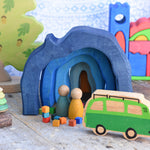 A small world play scene set up with the Glückskäfer Blue Grotto at the centre. The Glückskäfer Blue Castel can be seen in the background. 