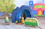 A small world play scene set up with the Glückskäfer Blue Grotto at the centre. The Glückskäfer Blue Castel can be seen in the background. 