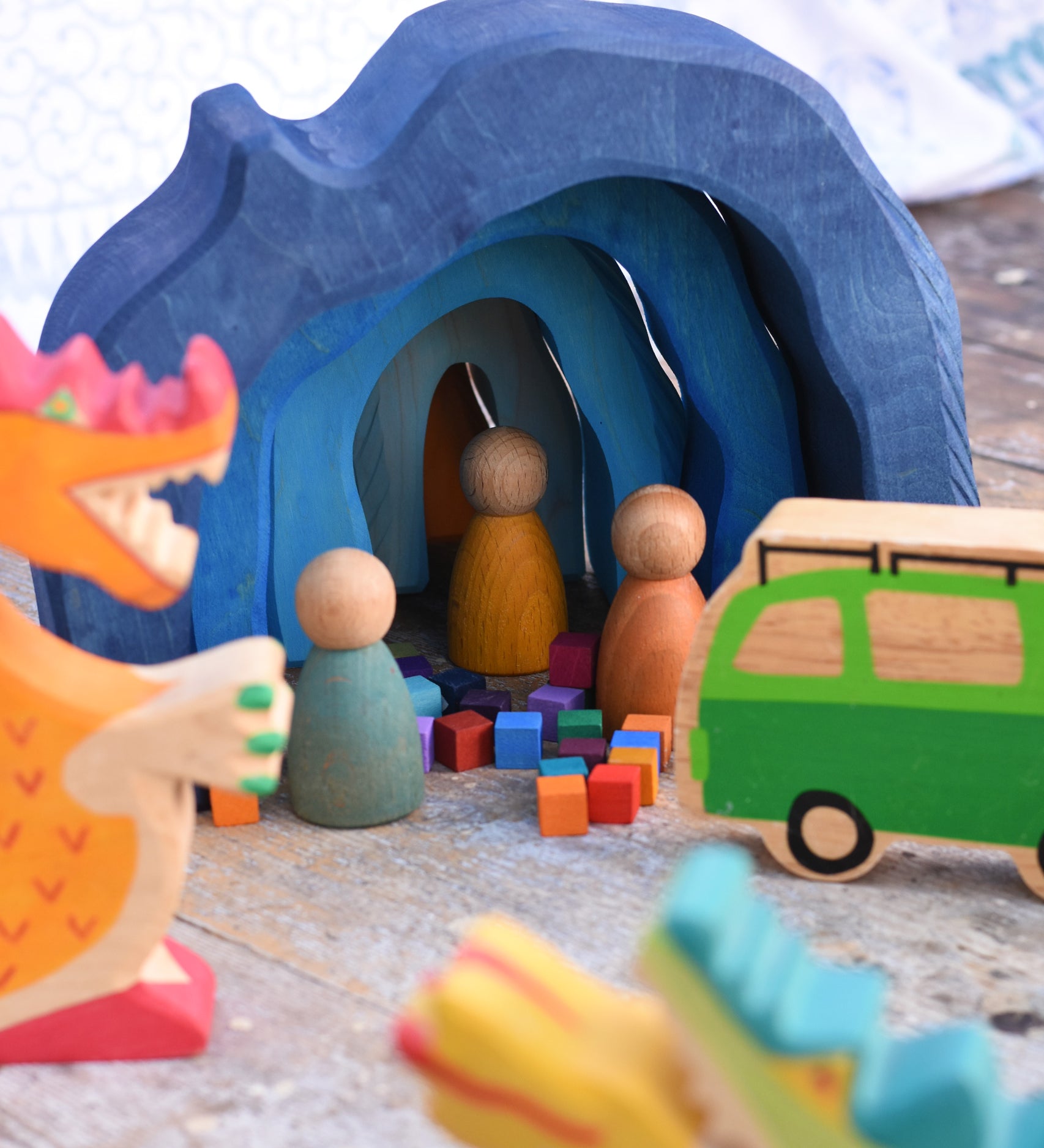 The Glückskäfer Blue Grotto used in a small world play scene with Holztiger wooden dragon figures and Grapat Nin peg dolls. 