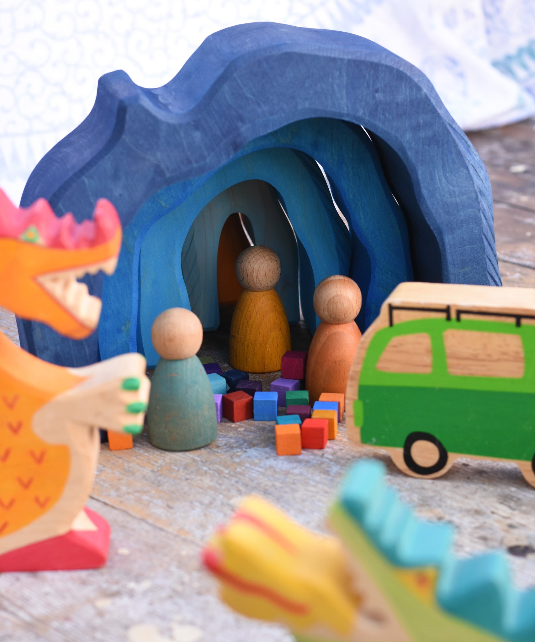 The Glückskäfer Blue Grotto used in a small world play scene with Holztiger wooden dragon figures and Grapat Nin peg dolls. 