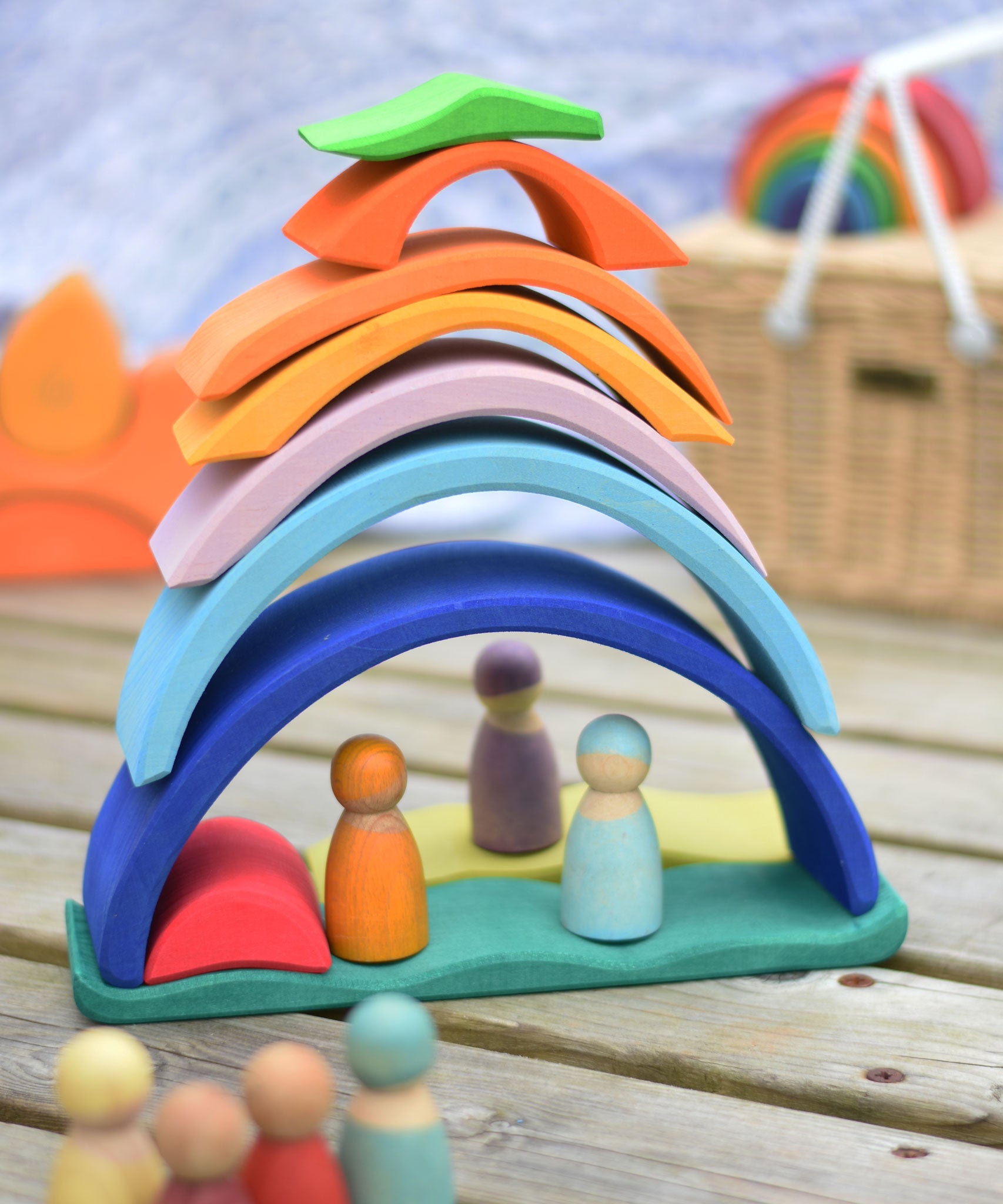 The pieces of the Glückskäfer Blue Sunrise Set stacked up to create a house for Grimm's friends wooden peg dolls.
