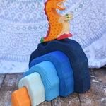A Holztiger red dragon placed on a Glückskäfer Blue Grotto.