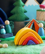 A small world play scene featuring the Glückskäfer Wooden Stacking Bonfire.