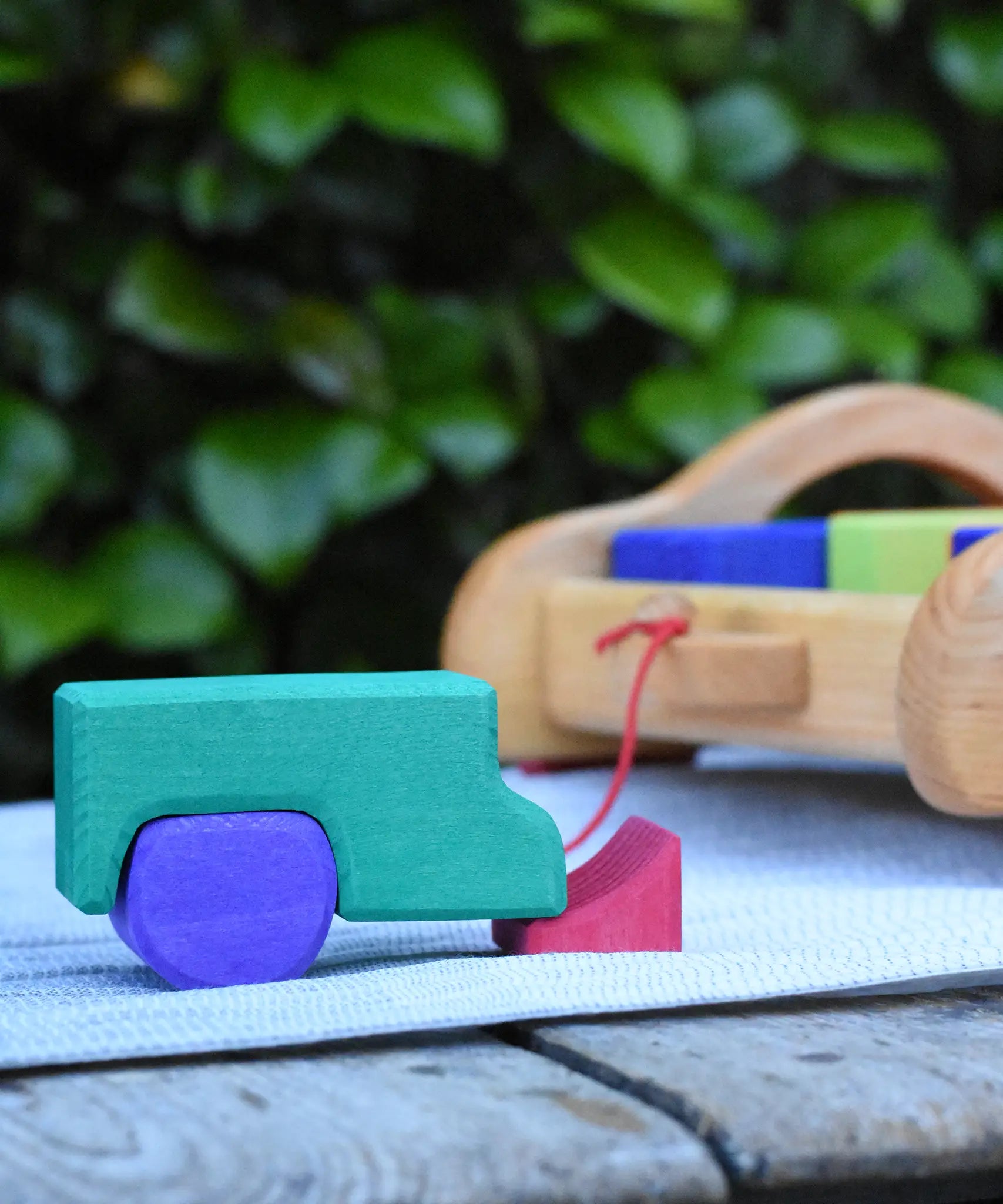 Blocks from the Gluckskafer carriage wooden toy block set used to create a  stack resembling a vehicle.