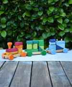 Glückskäfer colourful shape train wooden toy placed on a table outdoors. 