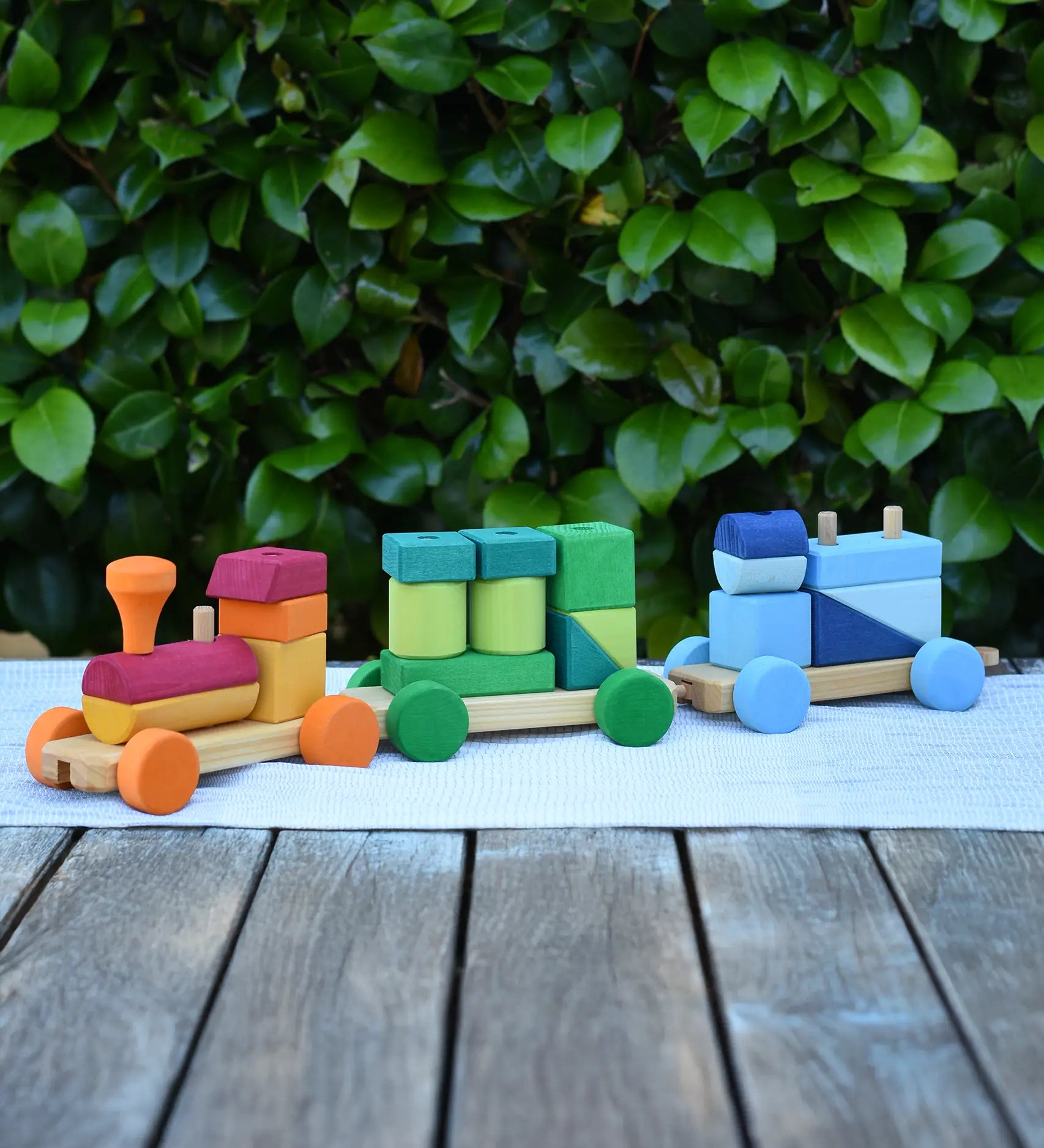 Glückskäfer colourful shape train wooden toy placed on a table outdoors. 