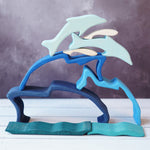 Wooden dolphin puzzle set in various shades of blue. The set includes a mixture of outlines and full-body shapes.