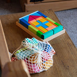 The Glückskäfer house b;locks in a tray set shown next to the 27 Piece Building Blocks Set in their net.