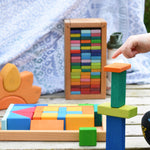 A child playing with the Glückskäfer 29-Piece House Blocks set. 