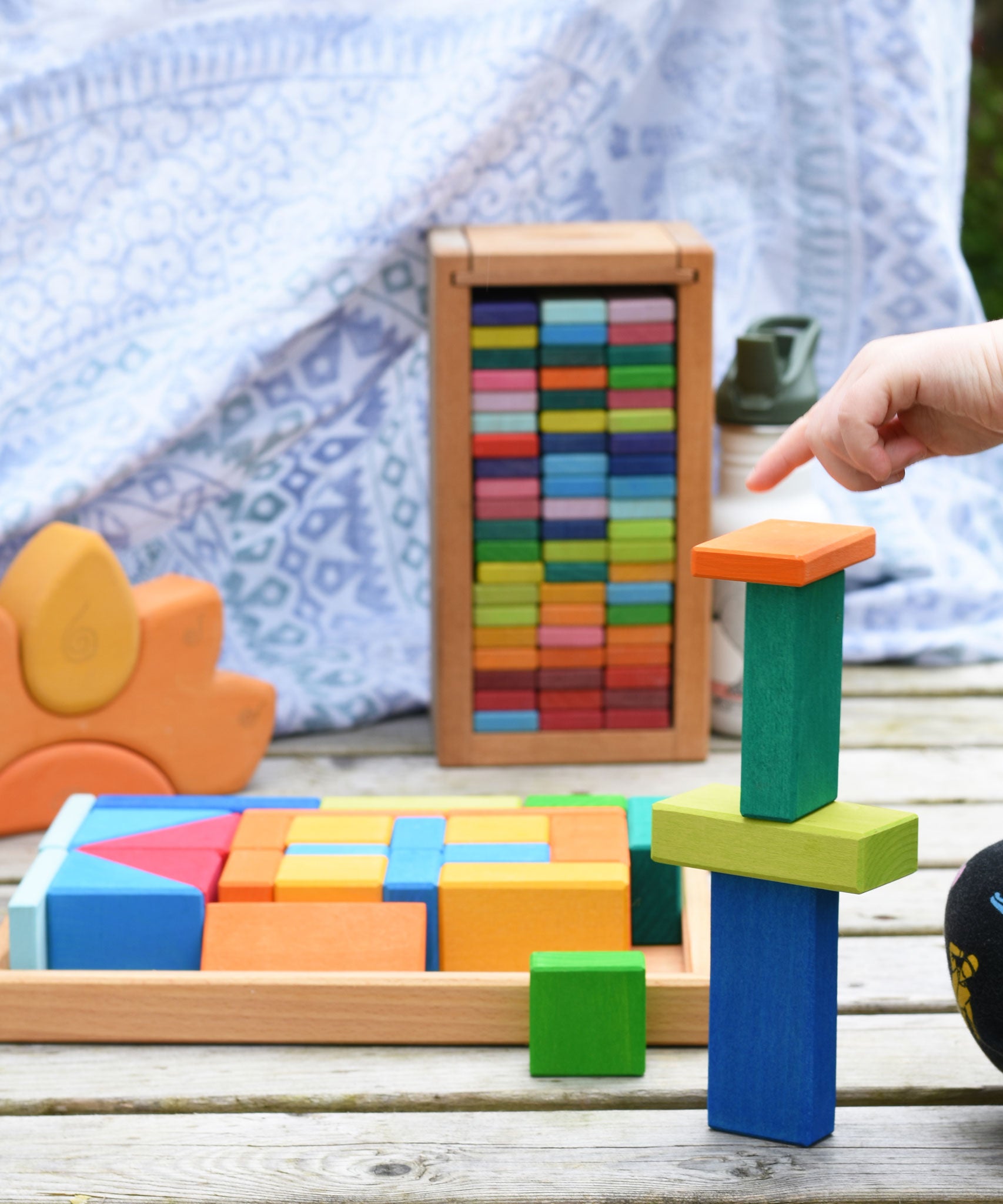 A child playing with the Glückskäfer 29-Piece House Blocks set. 