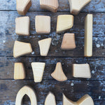The Glückskäfer 17 Large Natural Blocks laid out on a wooden surface. 