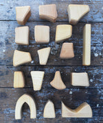 The Glückskäfer 17 Large Natural Blocks laid out on a wooden surface. 
