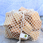 The Glückskäfer 17 Large Natural Blocks Set shown in their netting storage bag.