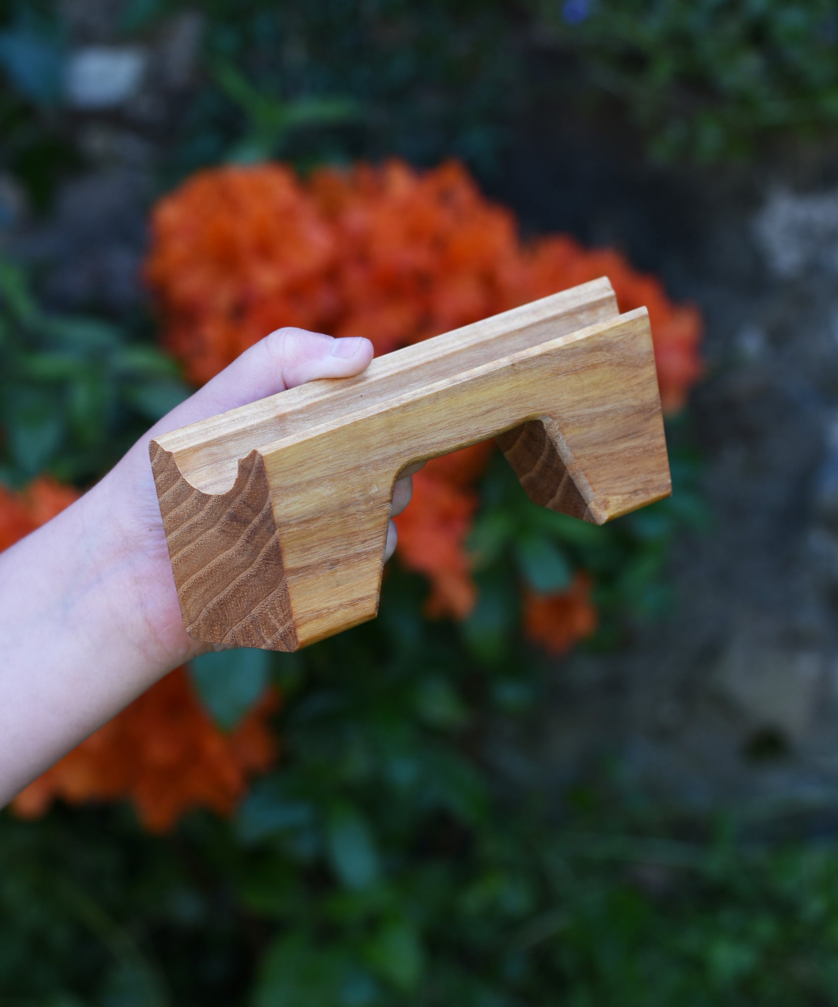 A bridge piece from the Glückskäfer Marble Track Bridge and Tunnel Set in a child's hand.