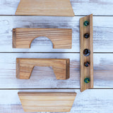 The pieces from the Glückskäfer Marble Track Bridge and Tunnel Set laid out on a wooden surface.