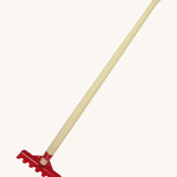 The Gluckskafer outdoor toy rake, with a long 60cm wooden handle and a red metal rake