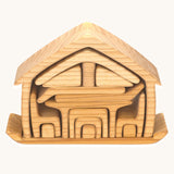 The Gluckskafer Natural All-In House wooden toy shown with all the pieces neatly stacked on it's base piece.