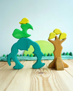 The Glückskäfer Wooden Pear Tree Stacking Puzzle Toy shown with the pieces taken off the trunk base piece. 