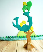 The Glückskäfer Wooden Pear Tree Stacking Puzzle Toy shown with the pieces balanced on each other.
