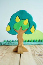 Glückskäfer Wooden Pear Tree Stacking Puzzle Toy shown on a wooden surface with other wooden toys seen in the background. 