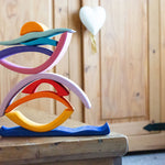 Glückskäfer wooden Purple Sunset Set Toy. The pieces have been stacked and balanced on top of each other. 