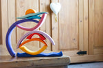 Glückskäfer wooden Purple Sunset Set Toy. The pieces have been stacked and balanced on top of each other. 