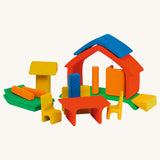 The Glückskäfer All-in rainbow coloured House shown with the pieces all separated. The table and chair pieces have been placed at the front. 