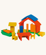 The Glückskäfer All-in rainbow coloured House shown with the pieces all separated. The table and chair pieces have been placed at the front. 