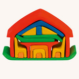Glückskäfer All-in House Rainbow wooden stacking toy with all the pieces neatly stacked in the house shape.