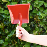 Glückskäfer red metal dust pan help up in a child's hand.