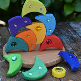 Glückskäfer sparkling swirl wooden spinning toy, pieces stacked up on the wooden circle base.