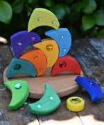 Glückskäfer sparkling swirl wooden spinning toy, pieces stacked up on the wooden circle base.