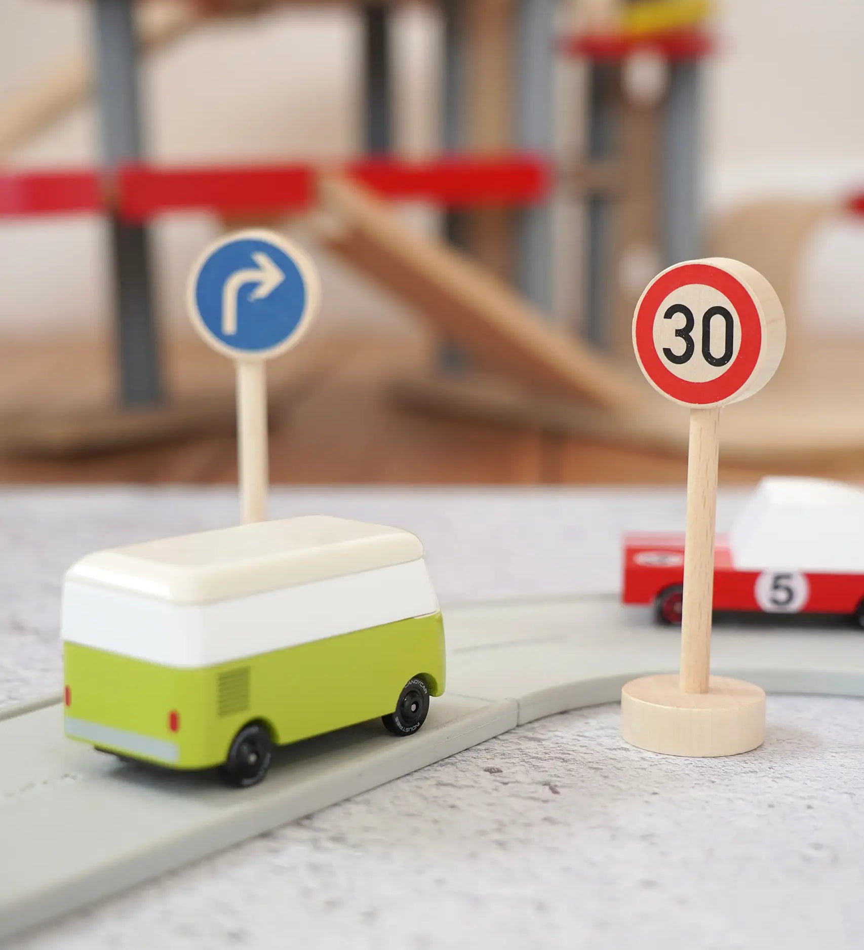 Gluckskafer miniature right turn traffic wooden sign next to a 30 speed limit sign and a playroad