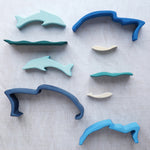 The pieces from the Gluckskafer Stacking Dolphin toy laid out. 