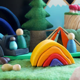 Close up of the Gluckskafer wooden bonfire on a green felt base surrounded by Grapat nins and lanka kade dan y ser toys in a campfire scene