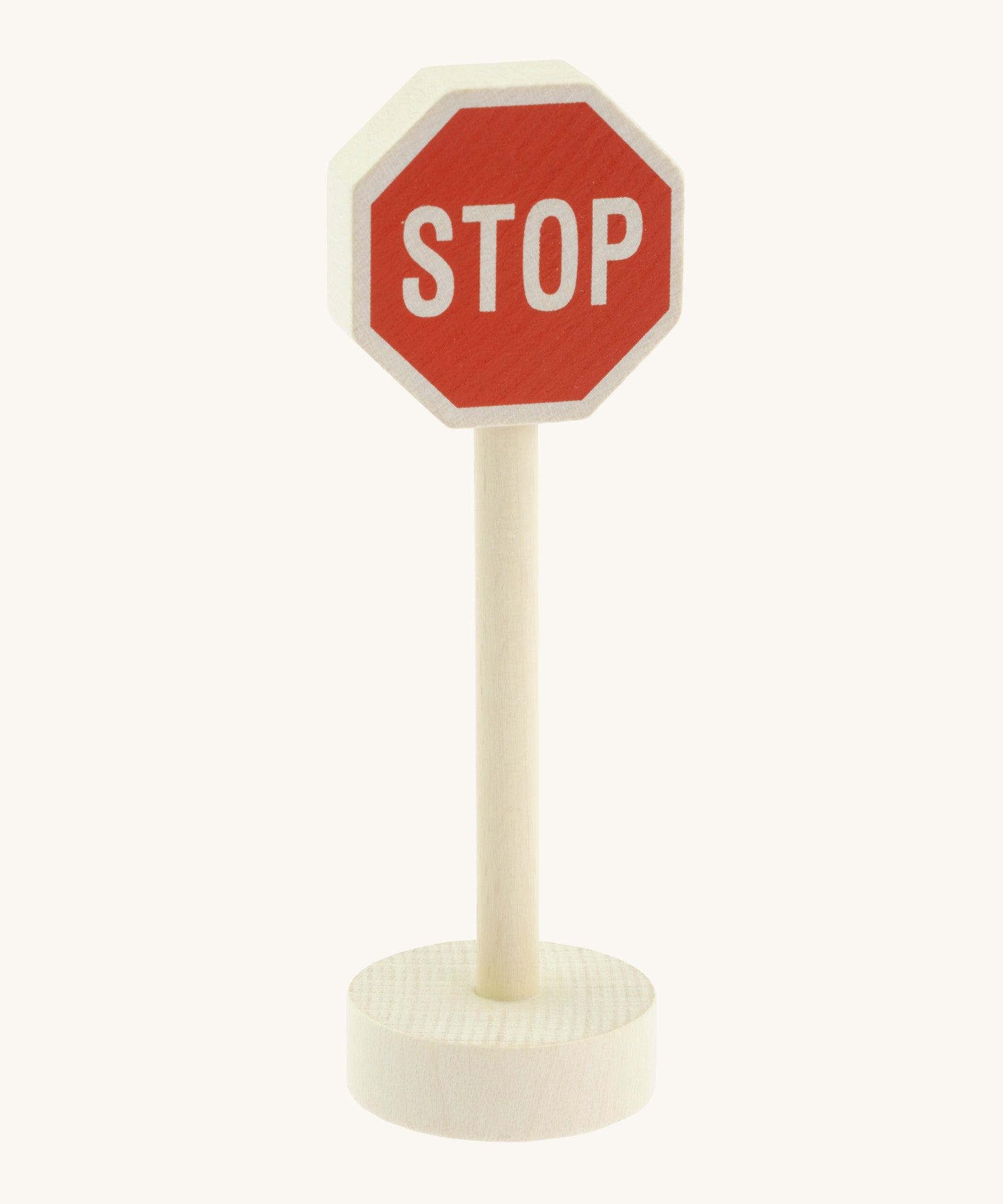 Gluckskafer small world wooden sign with stop in capital letters on a red sign