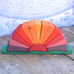The Glückskäfer Yellow Sunray Arch on a wooden surface with the top arch piece taken off.