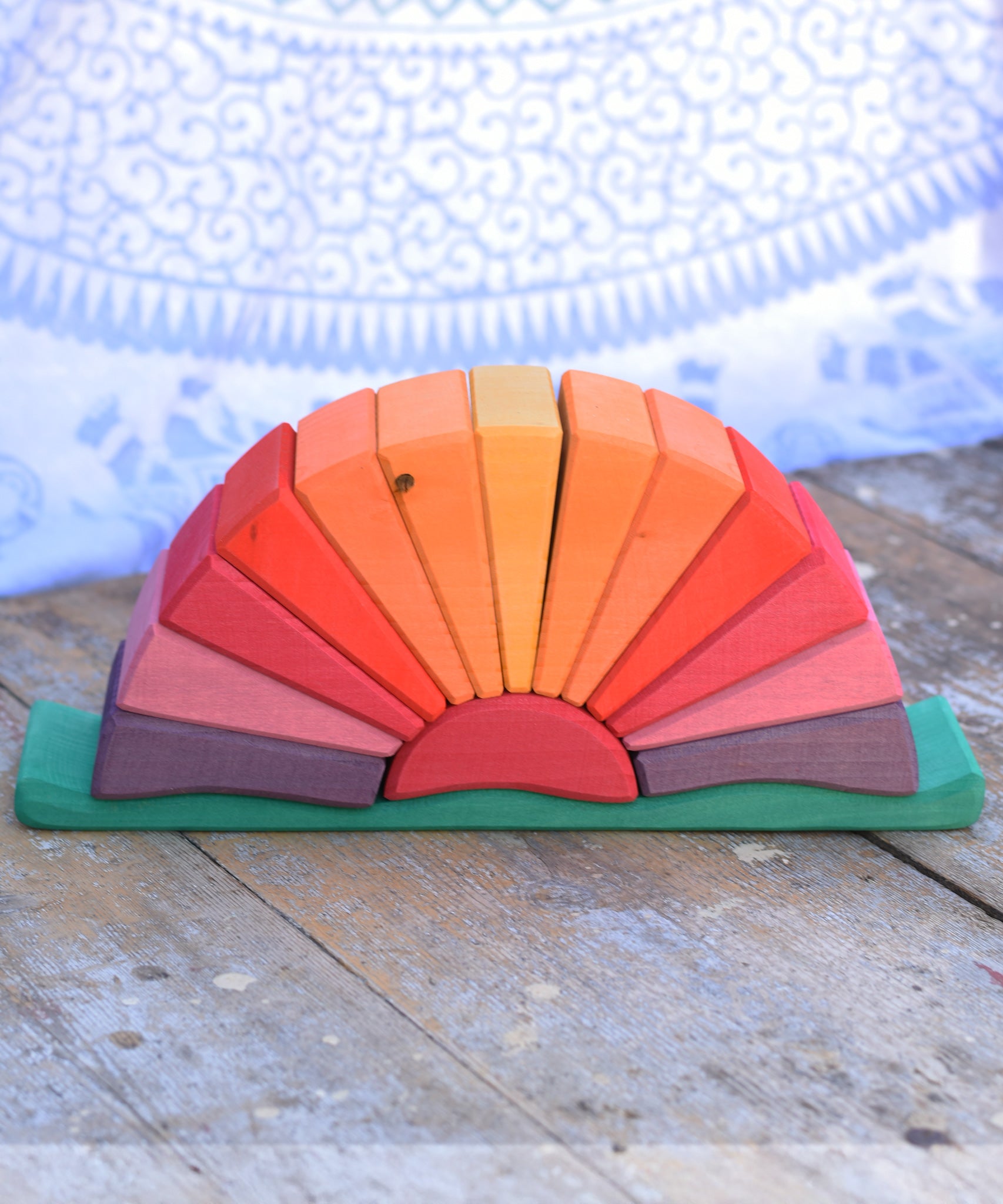 The Glückskäfer Yellow Sunray Arch on a wooden surface with the top arch piece taken off.